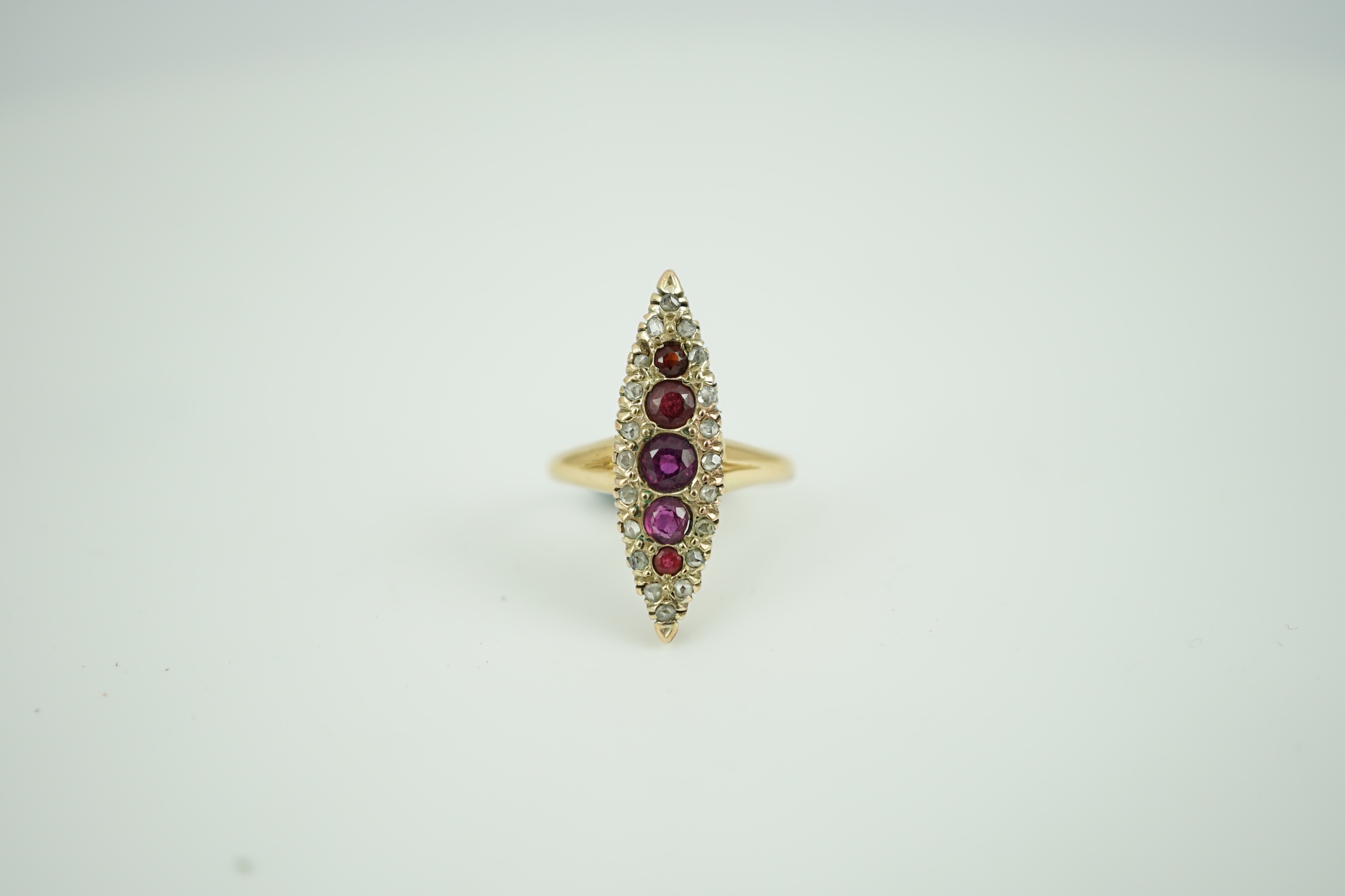 A late Victorian 18ct gold, ruby? and diamond marquise cluster set ring, size L, gross weight 3.5 grams.